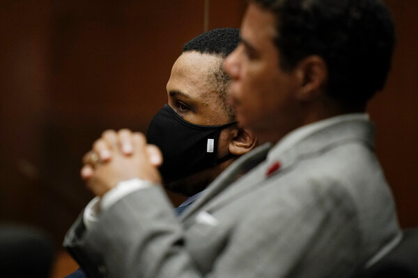 Eric R. Holder Jr., in court with his lawyer, Aaron Jansen, after the verdicts were read on Wednesday.