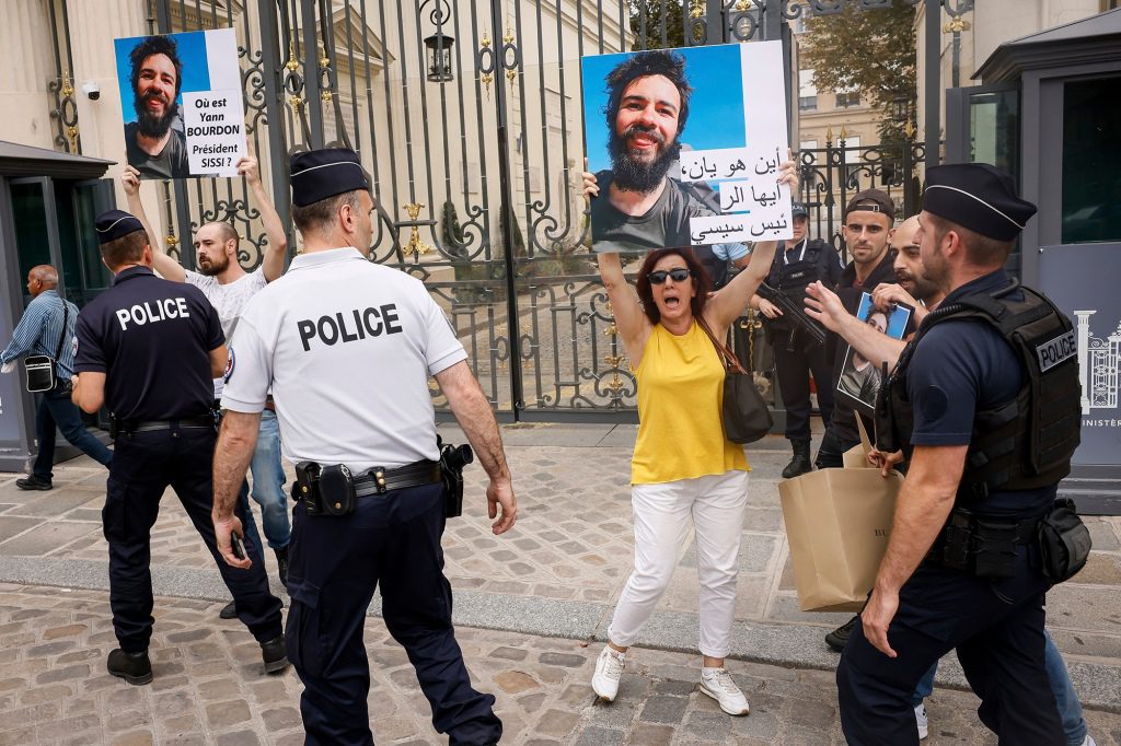 La famiglia e gli amici dello studente erano in piedi su un marciapiede a Parigi e tenevano i cartelli che chiedevano 